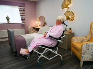 Lady in Mackworth M80 tilt-in-space shower chair